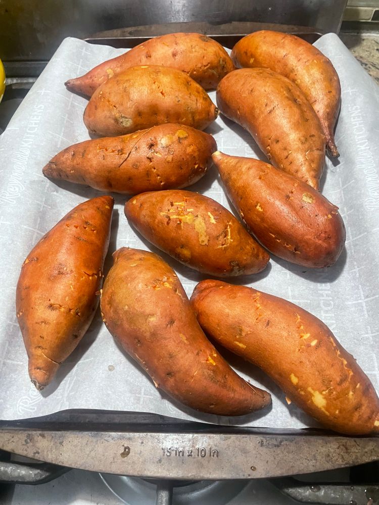 A sheet pan of whole sweet potatoes 