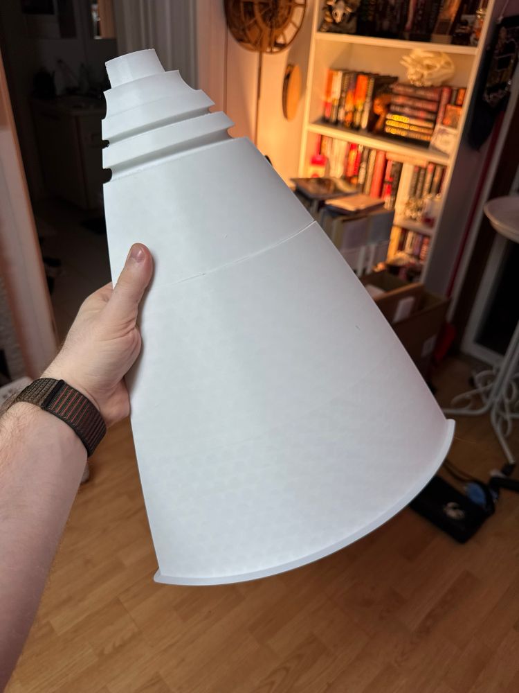 Fresh off the printer segments of the same piece as my other image, holding them in my hand to show the scale of the part