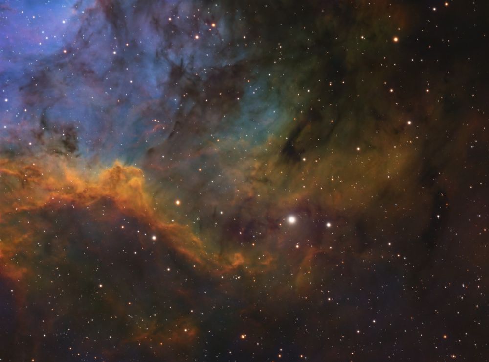 A corner crop of the nearby Soul Nebula (IC1848). Oxygen, sulfur, and hydrogen mix to create a gradient of blues, purples, greens, and reds.