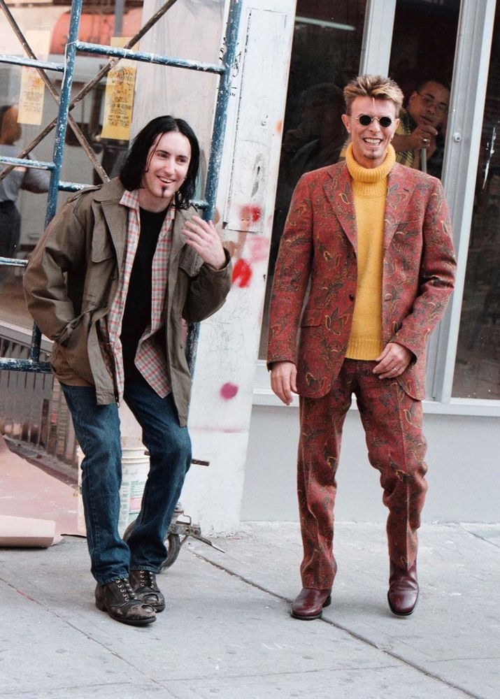 Trent Reznor and David Bowie on the set of the “I’m afraid of Americans” music video. Trent is dressed like he took inspiration from the show Friends.