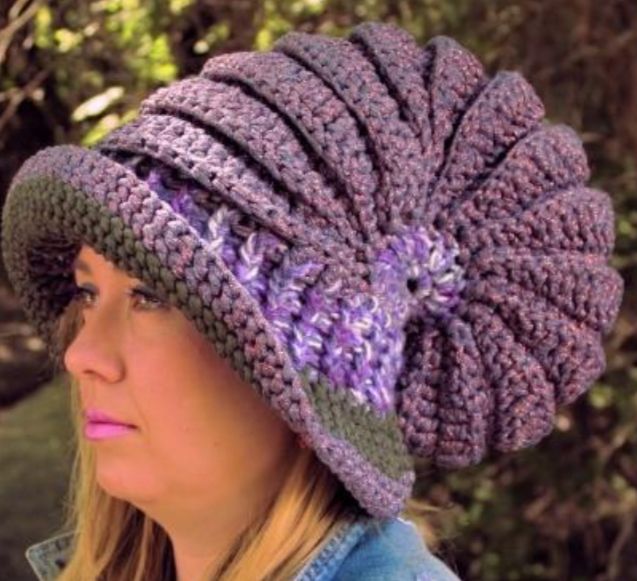 A photo by the creator of the pattern, showing the snail shell hat in all its glory. It’s huge, think a wizard’s hat, with a wide brim.