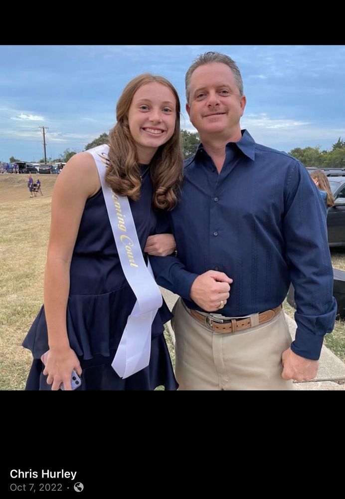 Chris Hurley, a white man, standing next to his daughter, presumably.