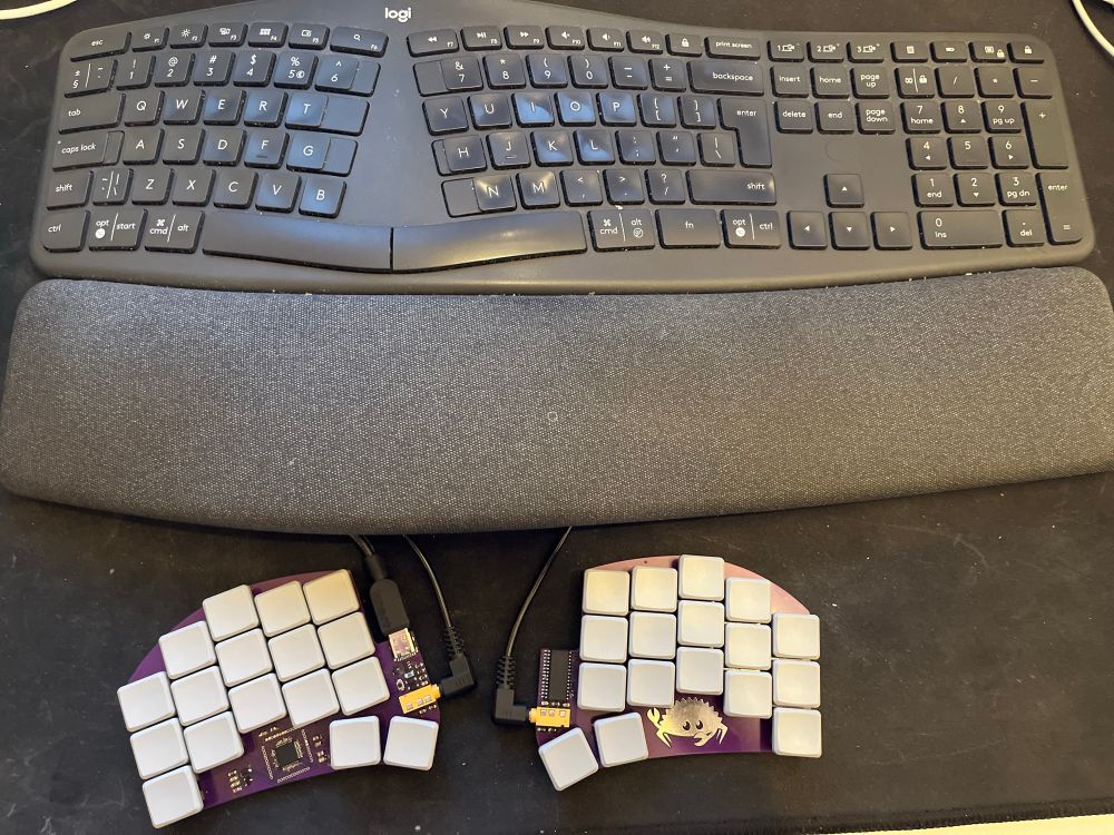 Two keyboards; one large logitech ergo split and one custom ferris compact split 34 keys