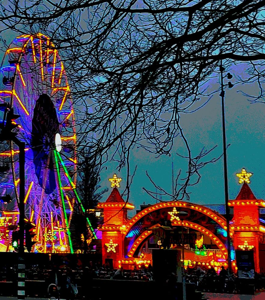 Fairground at dusk. A neon lit ferriswheel. The fairground entrance looking like a castle with neon stars on the castle towers.