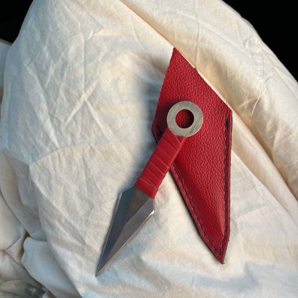 a small kunai wrapped with red leather and a matching sheath.