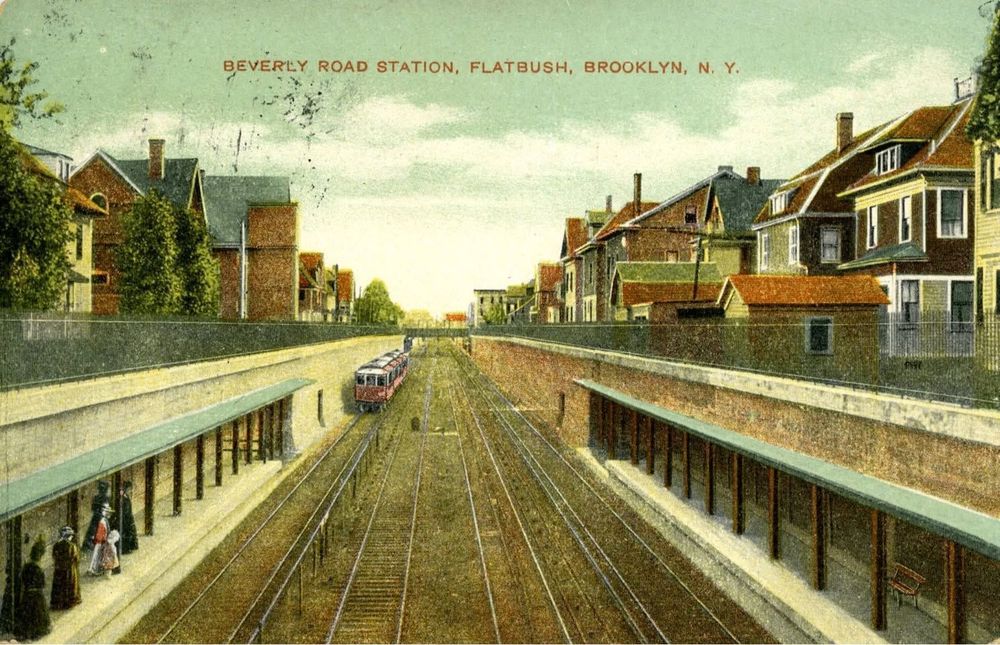 A postcard of an illustration of Beverly Road Station in Flatbush, Brooklyn. Large houses surround the station as a train approaches.