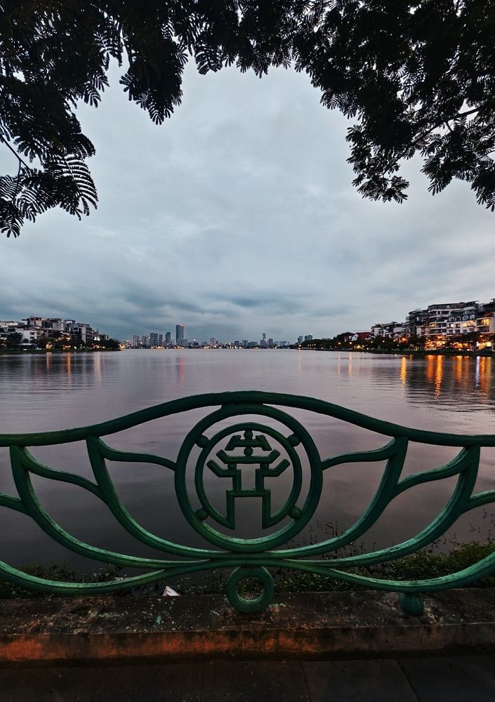 The Hanoi logo, aka the temple of literature, which is included in the railing around any lake. So here's the railing, a lake, and a nice city skyline behind 
