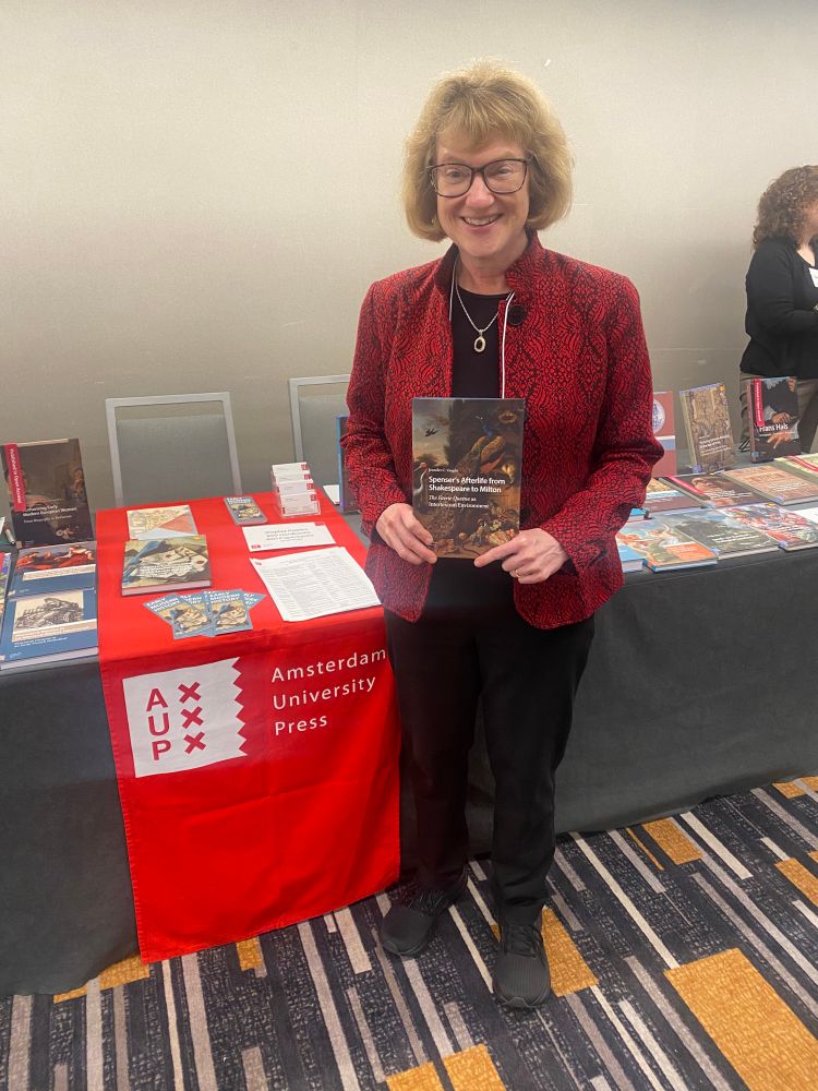 Jennifer C Vaught holds up her book 