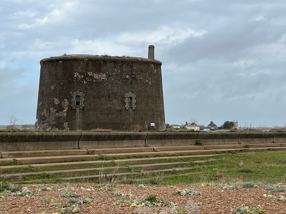 A Martello Tower on the seashore and another just visible in the distance