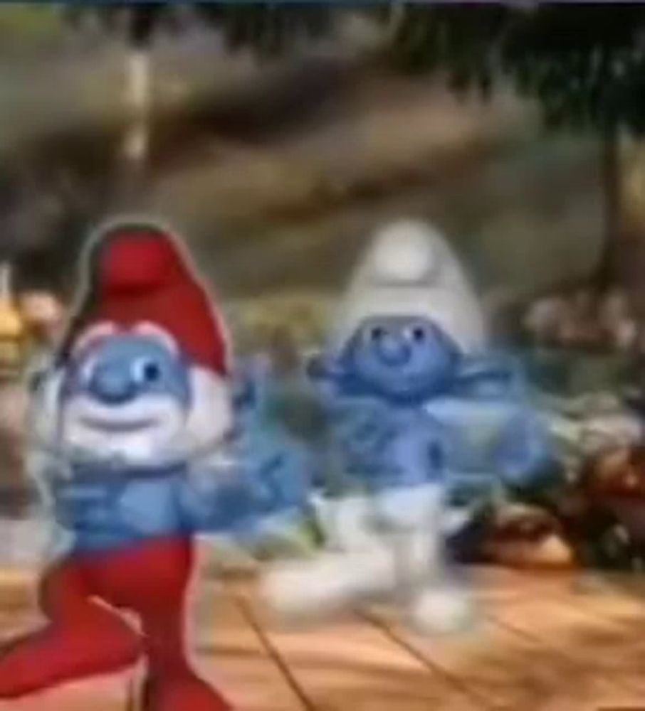 two smurfs are dancing on a wooden floor .