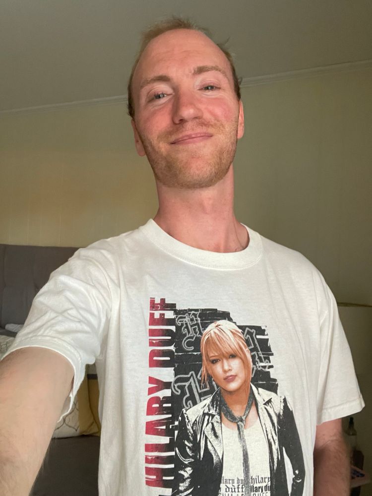 A selfie of me wearing a white Hilary Duff t-shirt