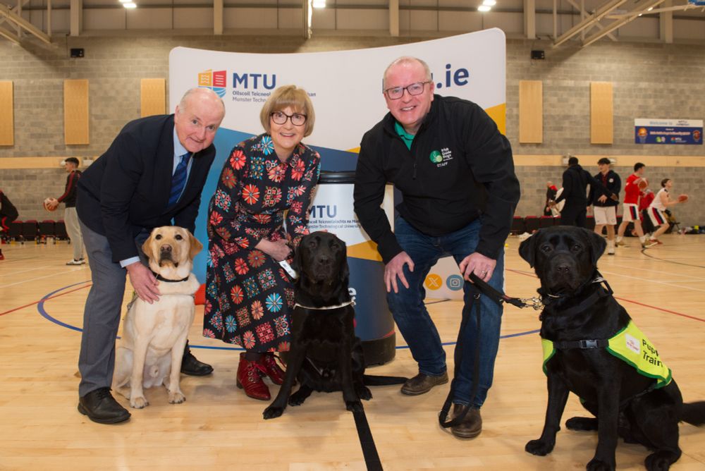 Ably assisted by guide dogs Slinky, Rocco and Otter are Michael Loftus, Vice President of External Affairs at Munster Technological University (MTU) with Maggie Cusack, President, MTU and Tim O'Mahony, CEO, Irish Guide Dogs for the Blind, at the signing of the Memorandum of Understanding between MTU and Irish Guide Dogs for the Blind at MTU Arena, Bishopstown on 25 January 2025.