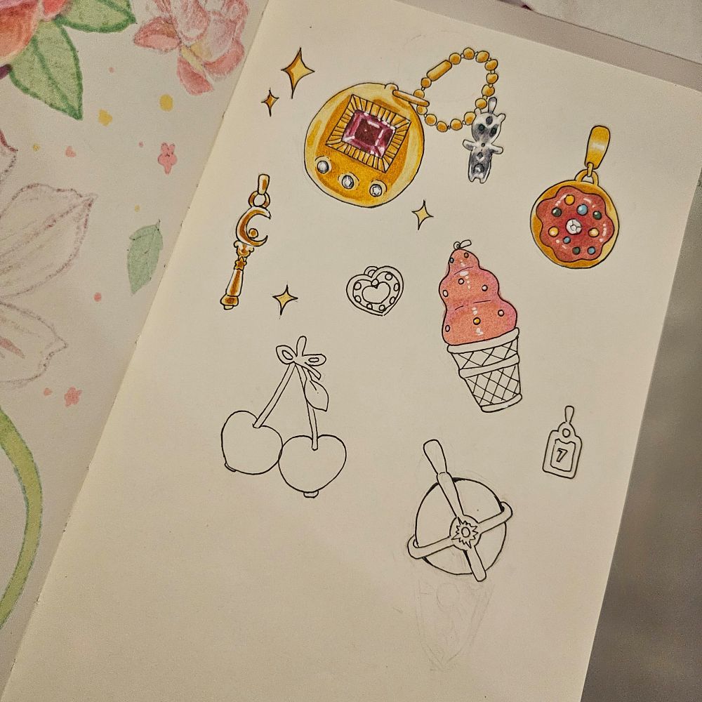 A sketchbook page with various charms drawn on it