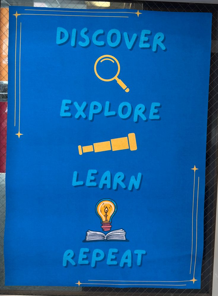 Poster with blue background.  The words discover, explore, learn, repeat in capital letters are listed.