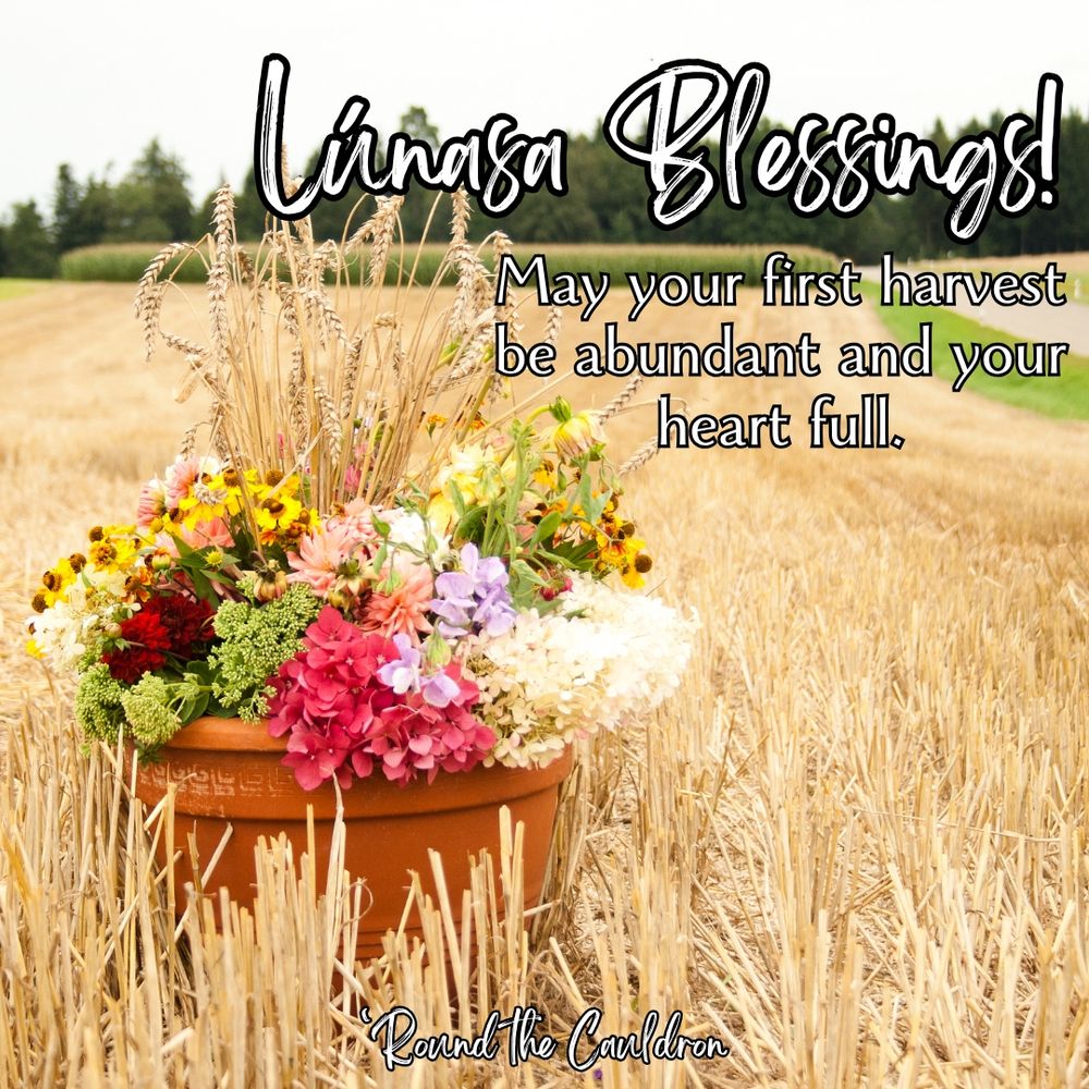 A pot of harvest flowers sits in a harvested wheat field. Text on the image reads, "Lúnasa Blessings! May your first harvest be abundant and your heart full."