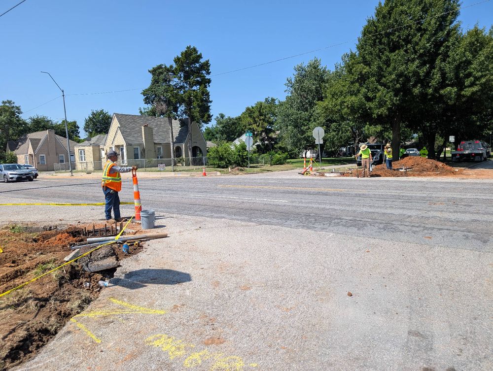 Construction workers installing a new traffic signal at NW 19th and May Ave in Oklahoma City.