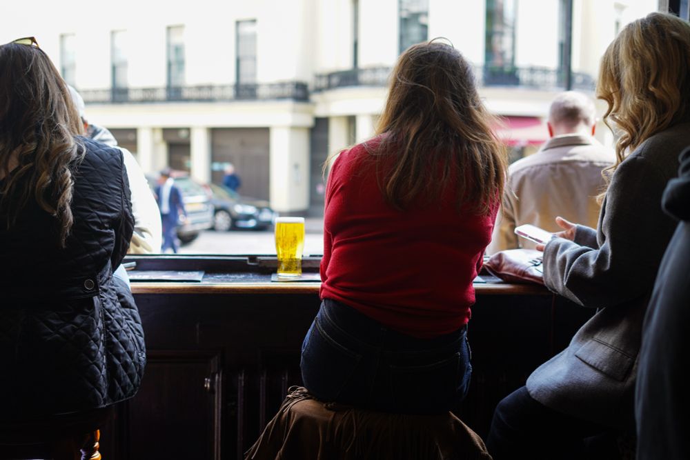 A few people sat in The Harp drinking with the big window open looking out over the street
