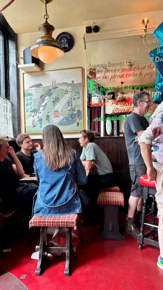 People sat chatting and drinking in The Cow
