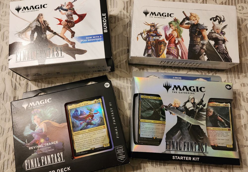 Several Magic the Gathering X Final Fantasy related sets: the bundle, the booster box, the Revival Trance Commander deck based on Terra from Final Fantasy 6, and the starter kit with two decks featuring Sephiroth and Cloud from Final Fantasy 7