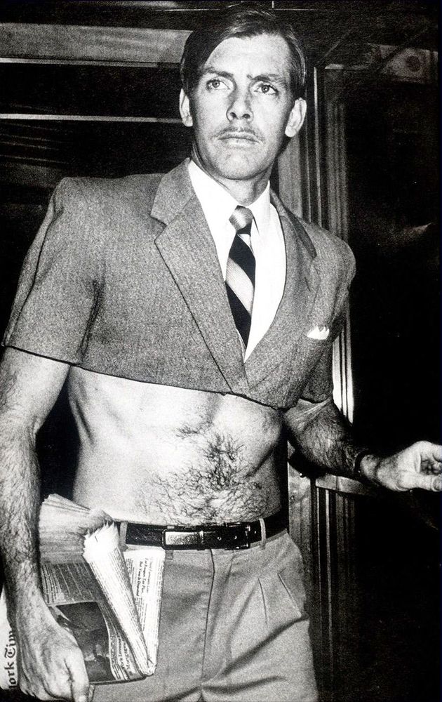 Pippa Garner's half-suit. From mid-chest up, it is a standard suit and tie, but it is cut off all the way across showing a bare stomach and lower arms