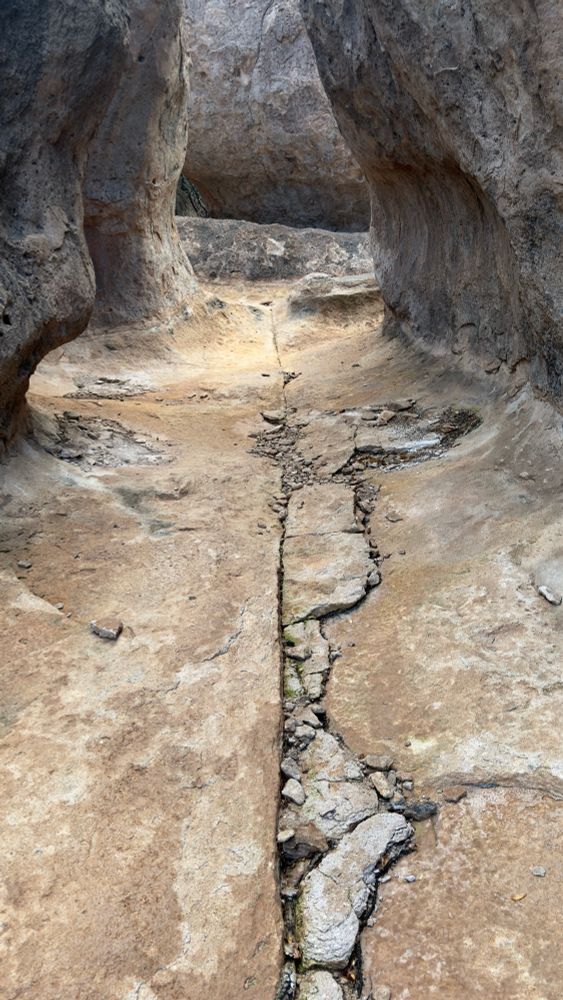 Rock formations in the City of Rocks, Faywood New Mexico, with a long vertical crack leading to the background between tall vertical rock formations.
