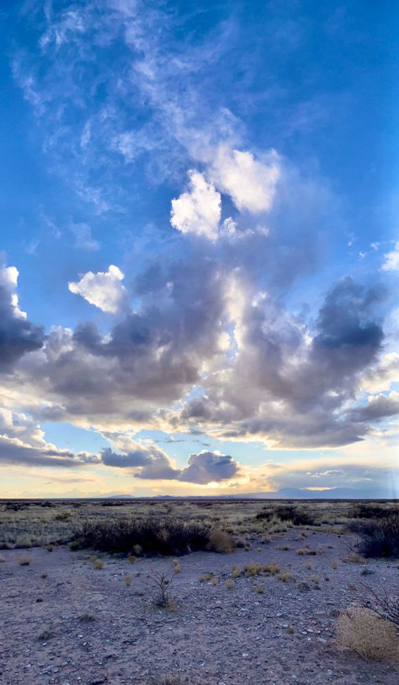 Image of a sunset, sky, clouds, and vast expanse with distance mountains near Fort Craig Historic Site, Socorro, New Mexico