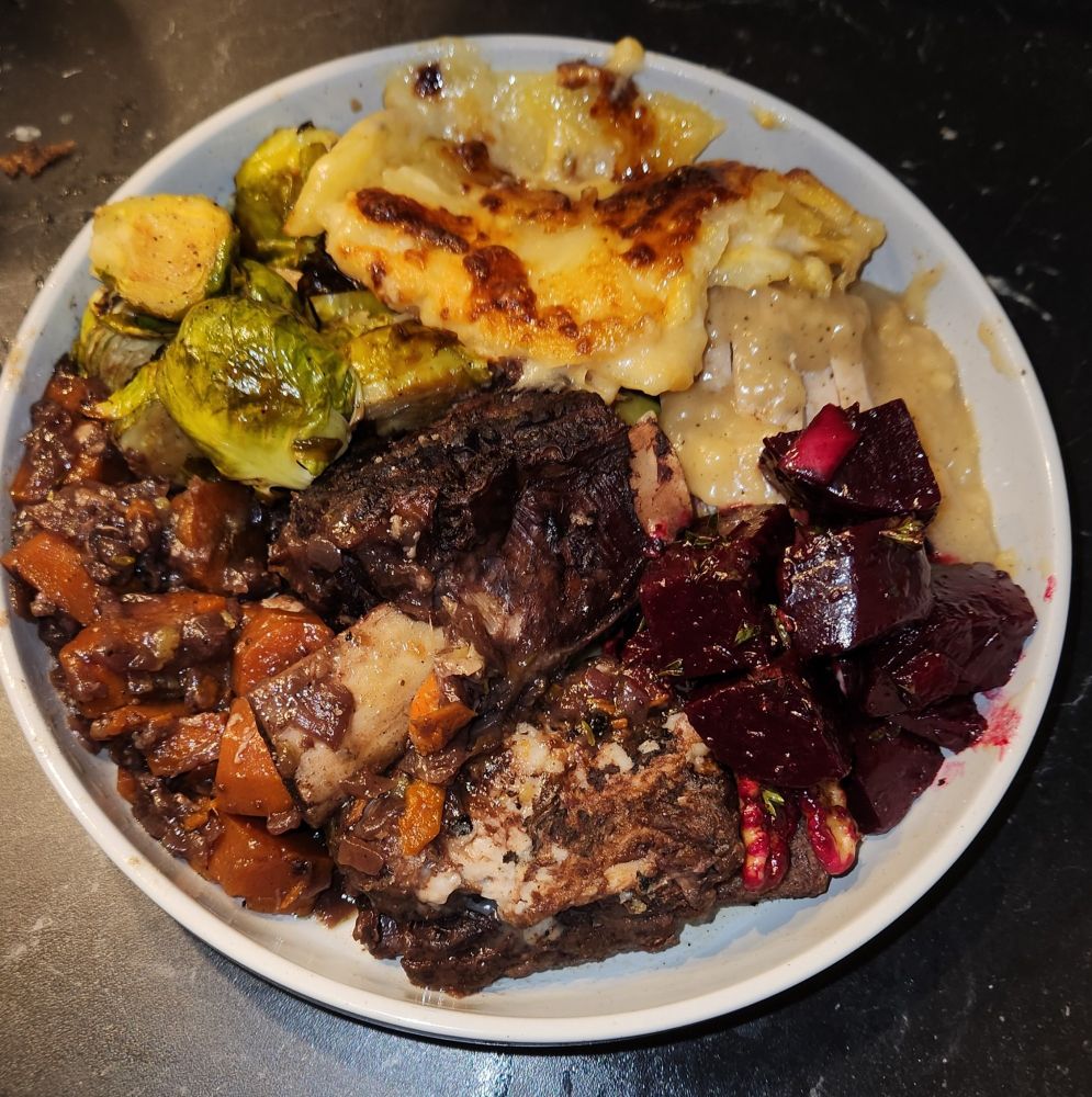 from north counterclockwise: scalloped potatoes, turkey and gravy, pickled beets, braised short rib with wine sauce and carrots, balsamic brussel sprouts. Gluten free cheddar biscuit side as well