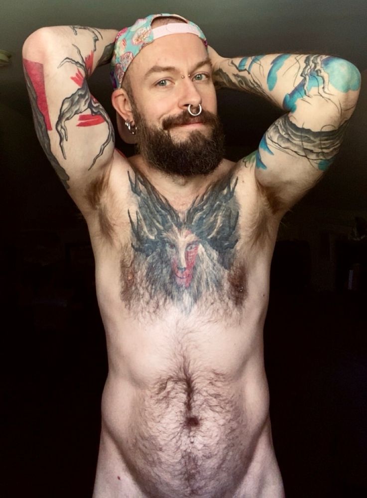 Standing naked in a well lit window