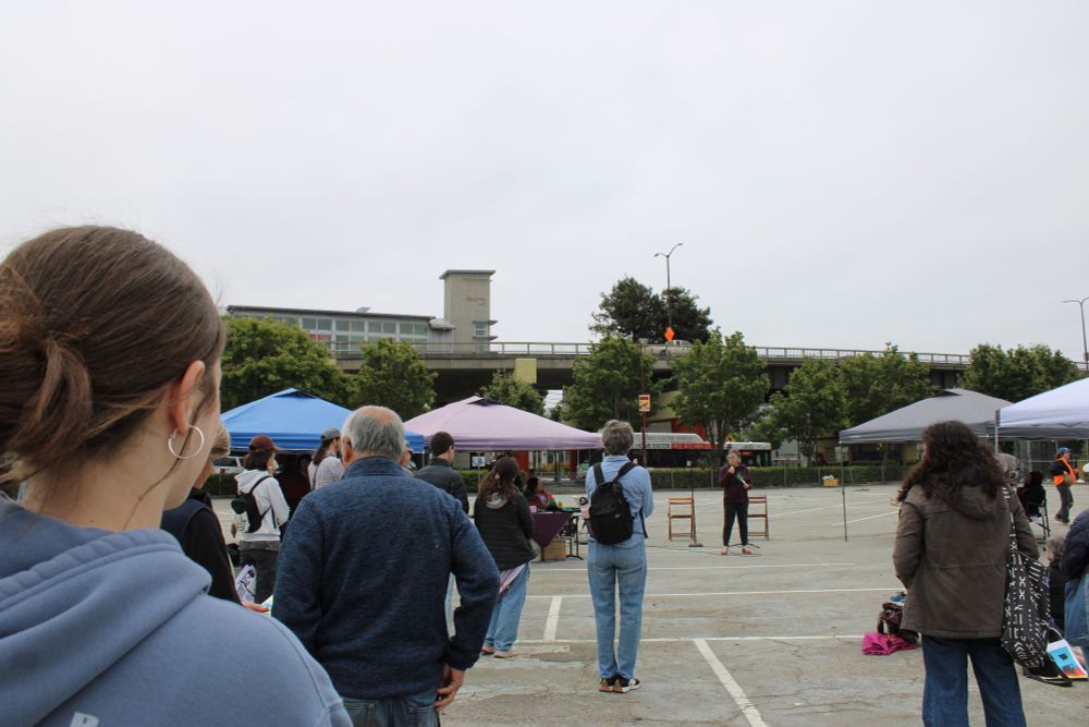 Crowd of people, many colored tents, person speaking with a mic. Photo credit: Noa_sc6, thaliasavv_