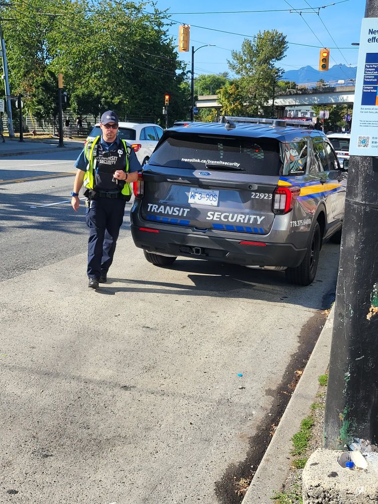 Transit security with SUV parked in street.