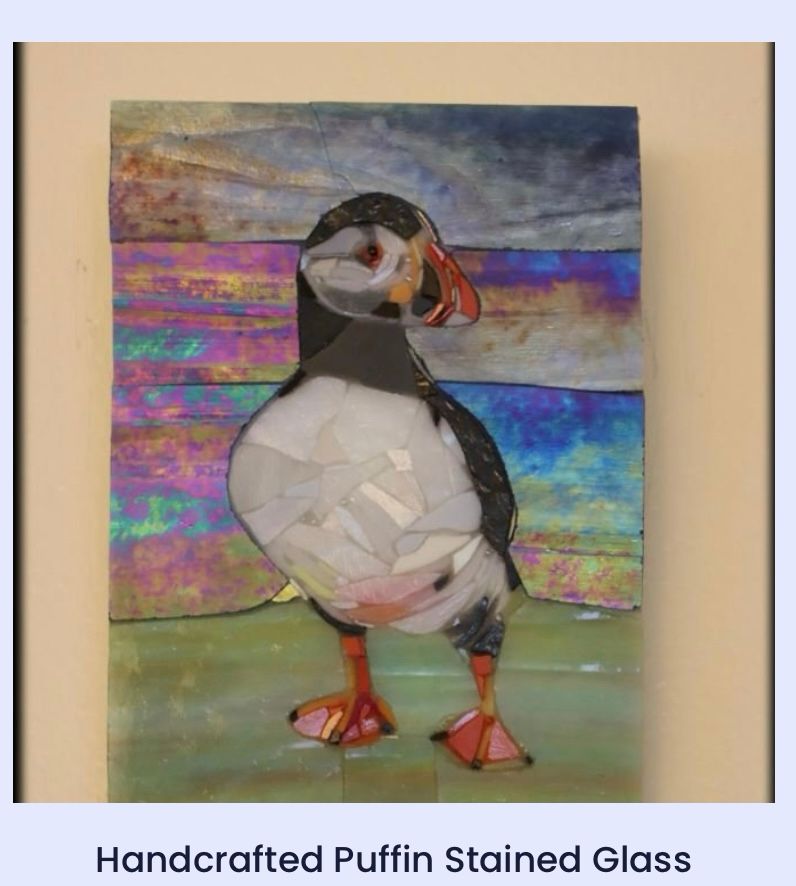 My stained glass mosaic of a puffin perched on a hillside.