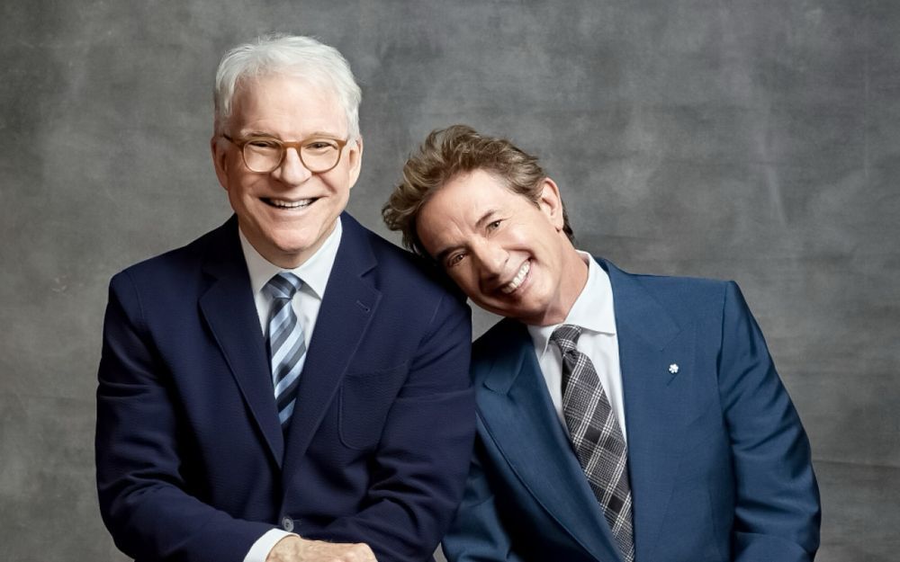 a photo of Steve Martin and Martin Short. Short has his head on Steve's shoulder.