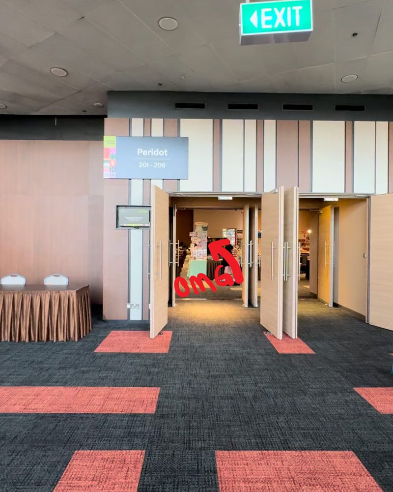 A photo from the stamp rally entrance of the Art Riot event hall, showing how amazingly visible JunBun's booth set-up is from the door.