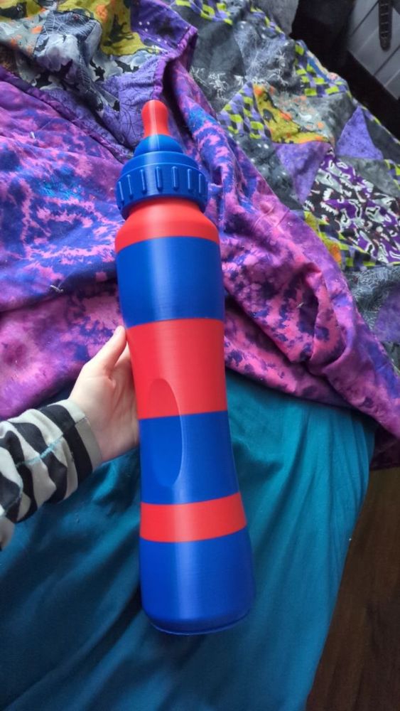 A print of a baby bottle game mat case in someone's hand. 