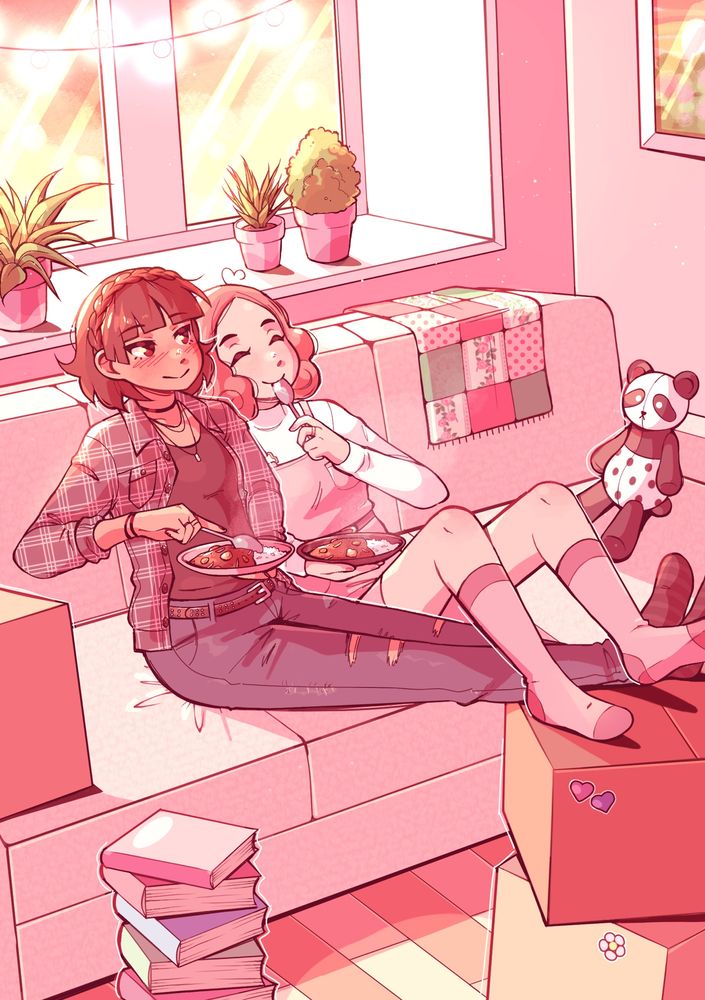 Makoto and Haru cuddling on a couch together while eating curry. Their feet are propped up on boxes and the room is filled with different items, such as a pile of books on the floor and plants on the windowsill behind them.