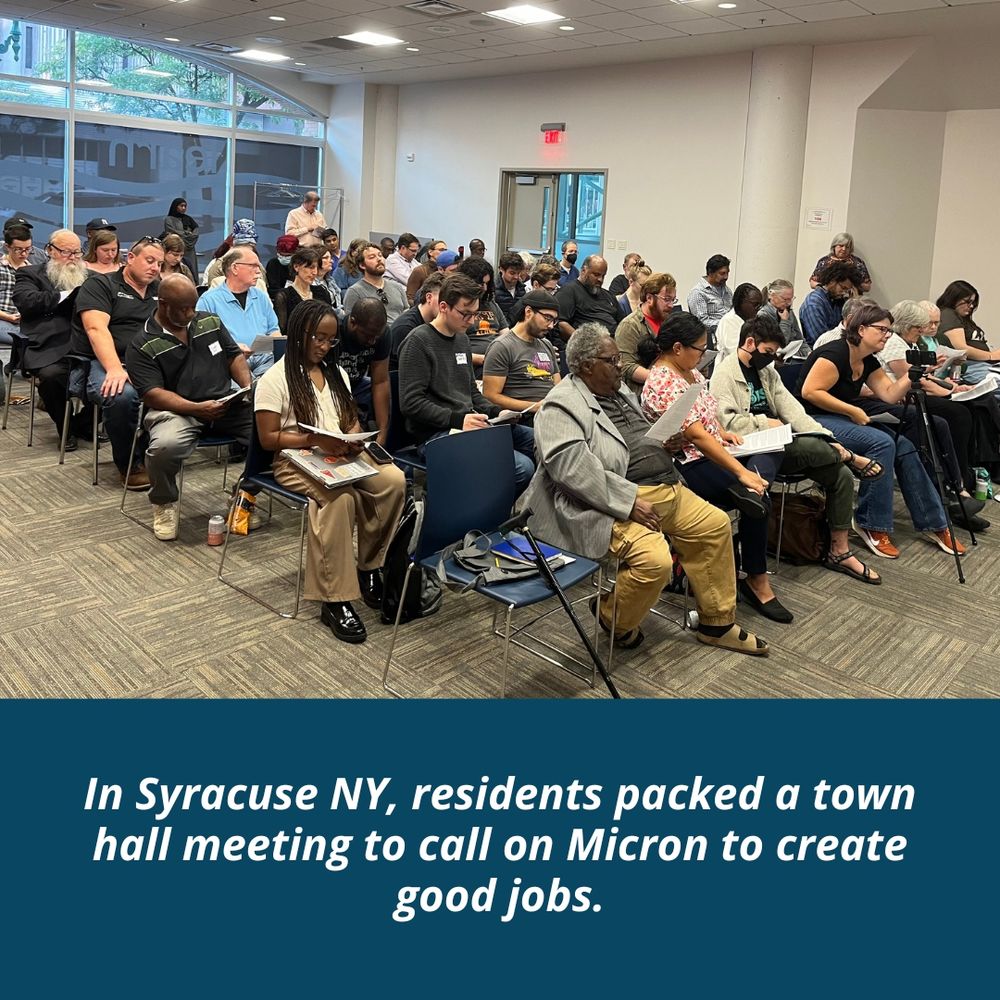 Photo of about 40 people sitting in chairs in a classroom setting looking at paper handouts.