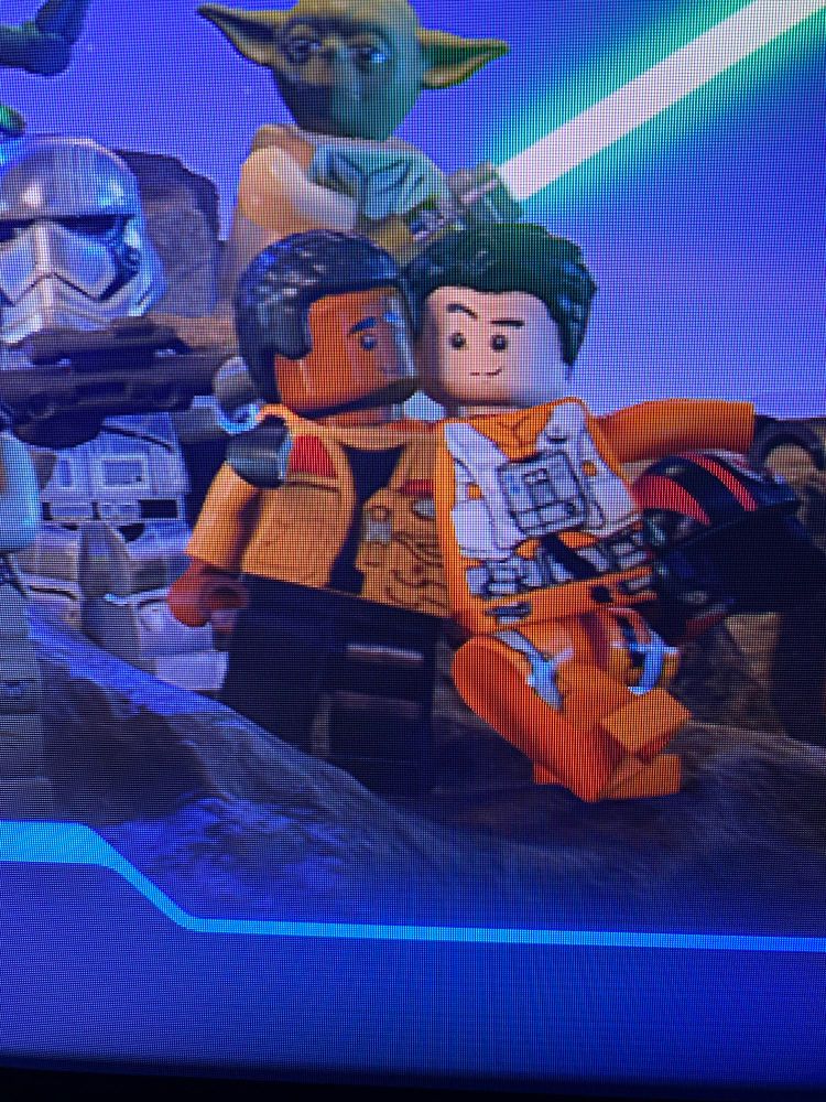 Lego versions of Finn and Poe from the Star Wars sequel trilogy look lovingly into each other’s sticker eyes