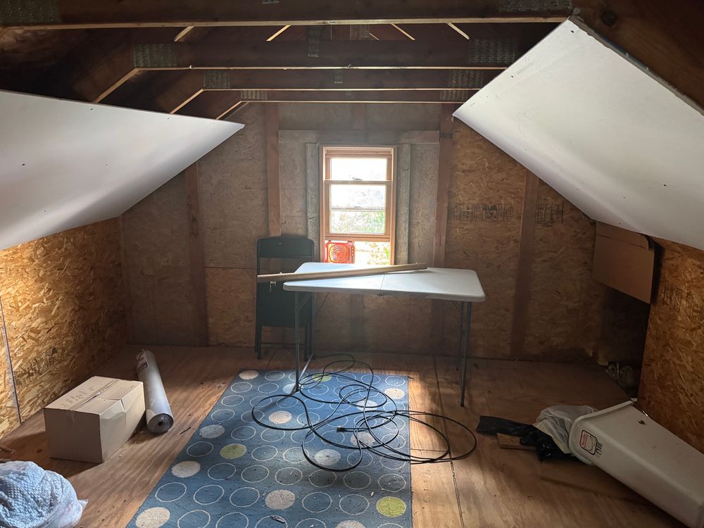 Drywall hung on angled roof sections of the garage attic. 