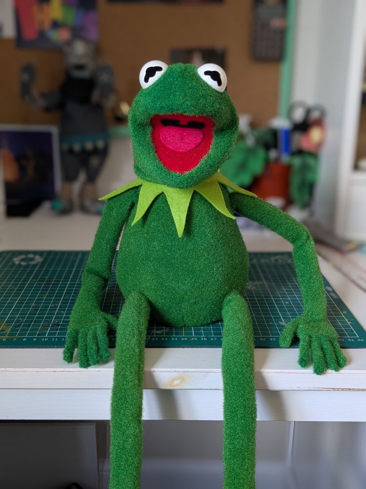It's replica Kermit the Frog, sitting on my desk looking happy to be alive.