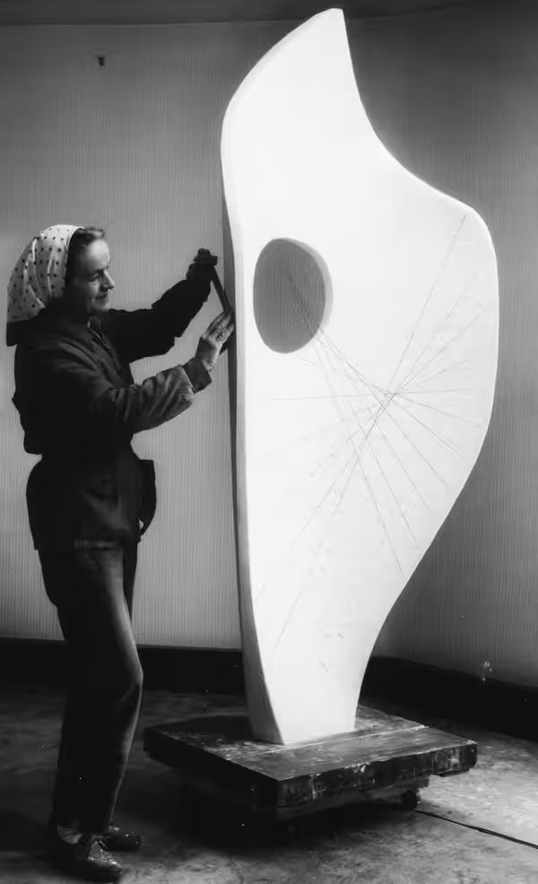 British artist Barbara Hepworth with the plaster of Curved Form (Bryher II) in her studio in St Ives, England in 1961. Photograph: Studio St Ives © Bowness