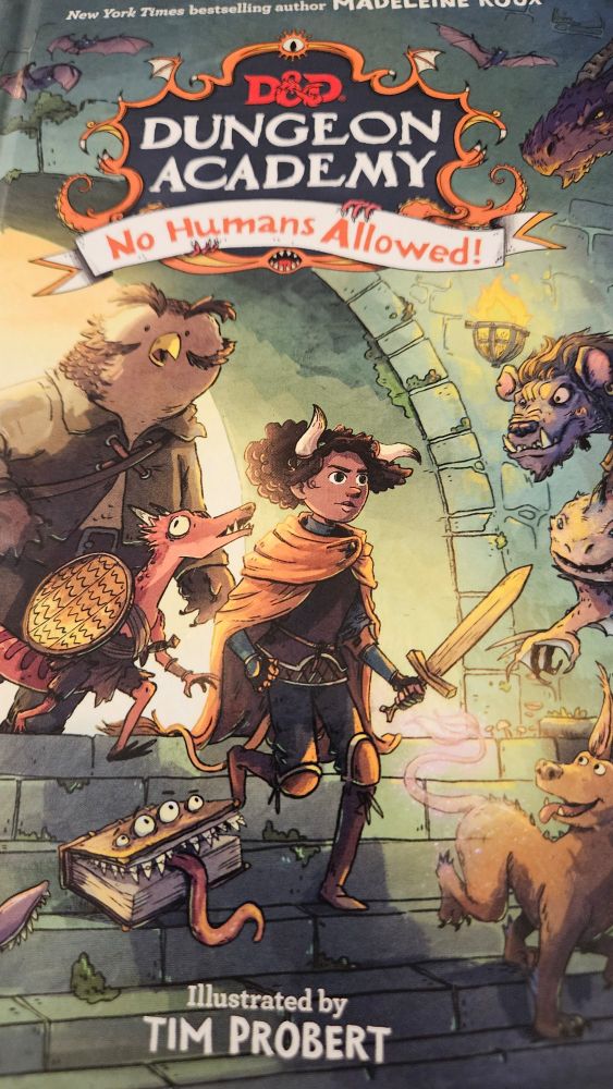 Color illustration on a book cover with an owlbear, dragon, and tiefling girl entering a dungeon room.