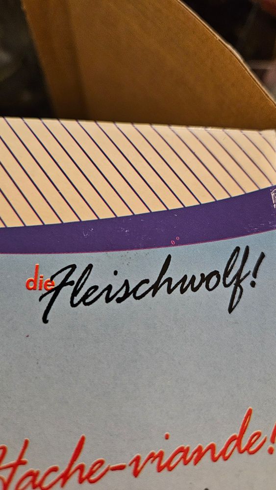 Meat Grinder packaging with the title "Die Fleischwolf!" in flamboyant cursive font. Die Fleischwolf hungers for your fingers...