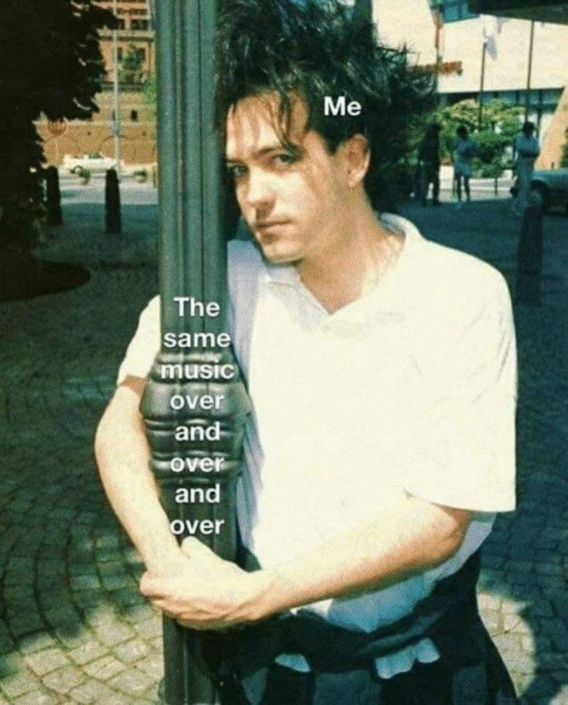 Robert Smith umarmt eine Laterne, über ihm steht "me" auf der Laterne steht: "the same music over and over and over"