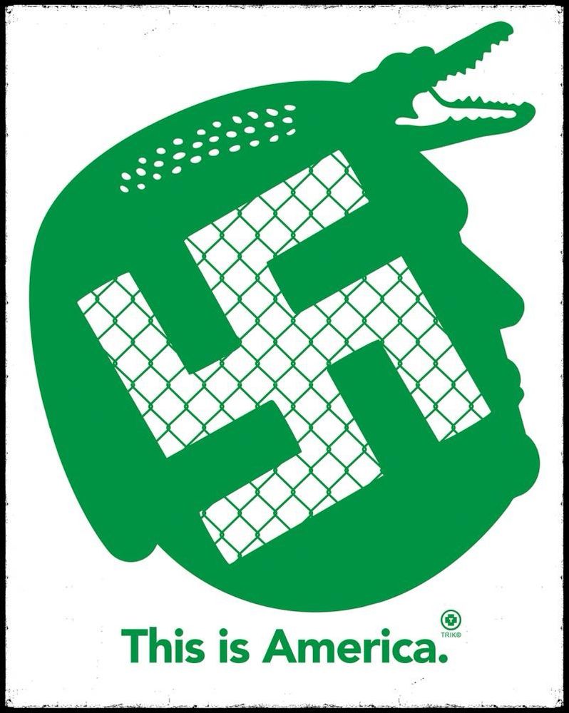 The image depicts a stylized, green silhouette of a human head wearing a helmet, with an alligator’s open mouth forming the top part. A swastika is prominently integrated into the design, overlaid with a chain-link fence pattern. The text at the bottom reads “This is America.” in bold green letters, accompanied by a “TRIKO” logo. This appears to be a satirical or provocative reference to a fictional “alligator Alcatraz” camp associated with Trump, blending symbols of authoritarianism and imprisonment.

