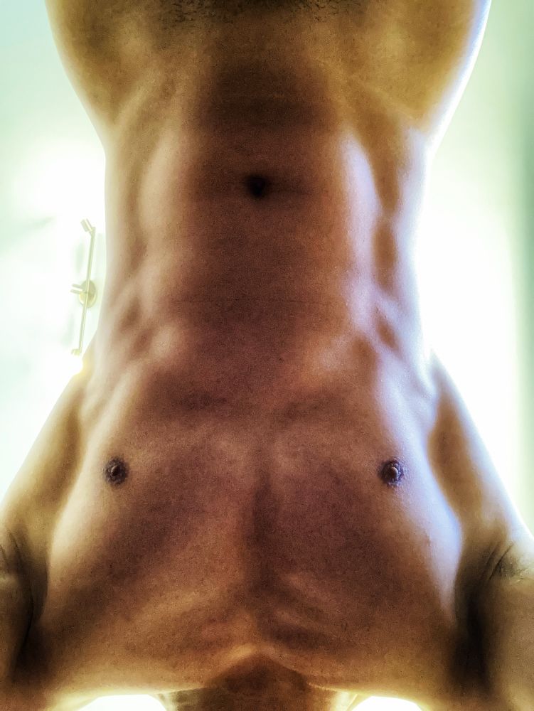Bottom-up POV, upside-down view of a fit male torso