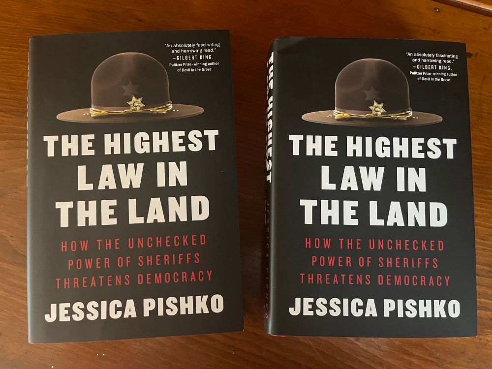 Photo showing two hardcover copies of the book “The Highest Law in the Land” by Jessica Pishko.
