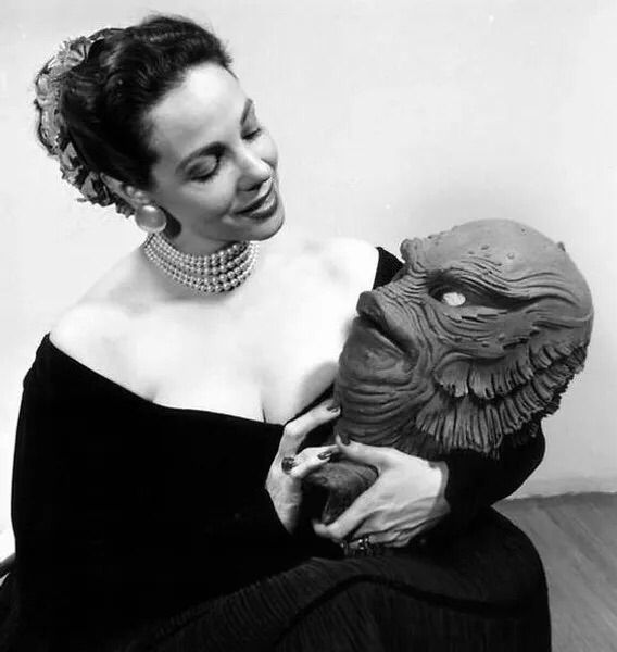 Photo of Milicent holding the creature head/mask