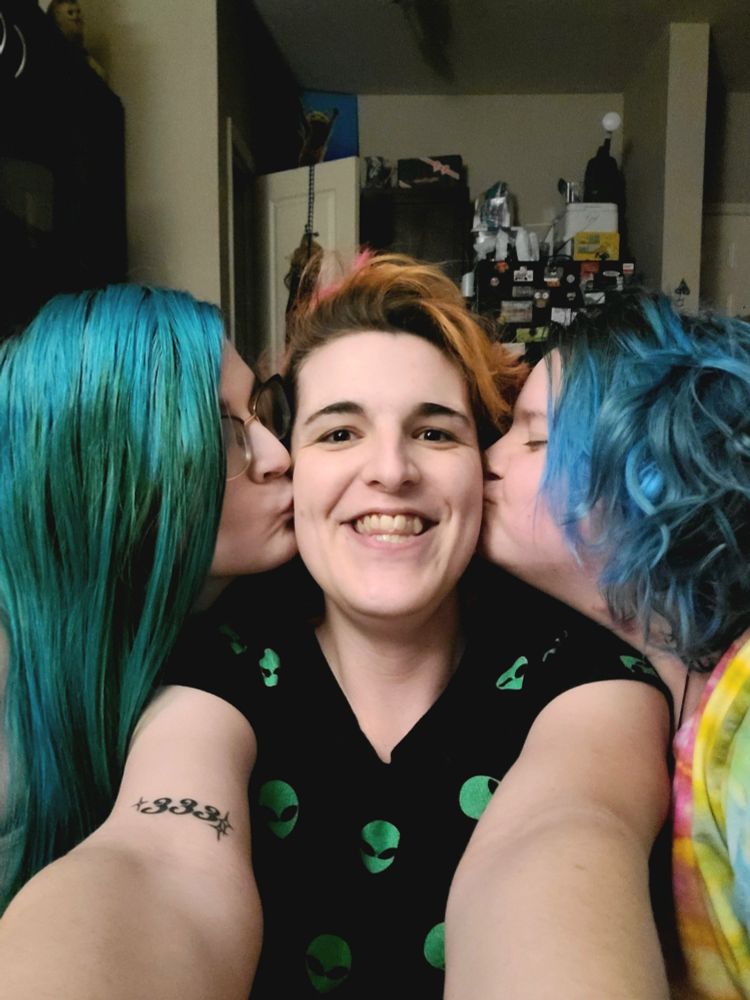 from the left, rogue, bailey, and ducky- ducky and rogue are kissing bailey on each of her cheeks, and bailey has the biggest grin
