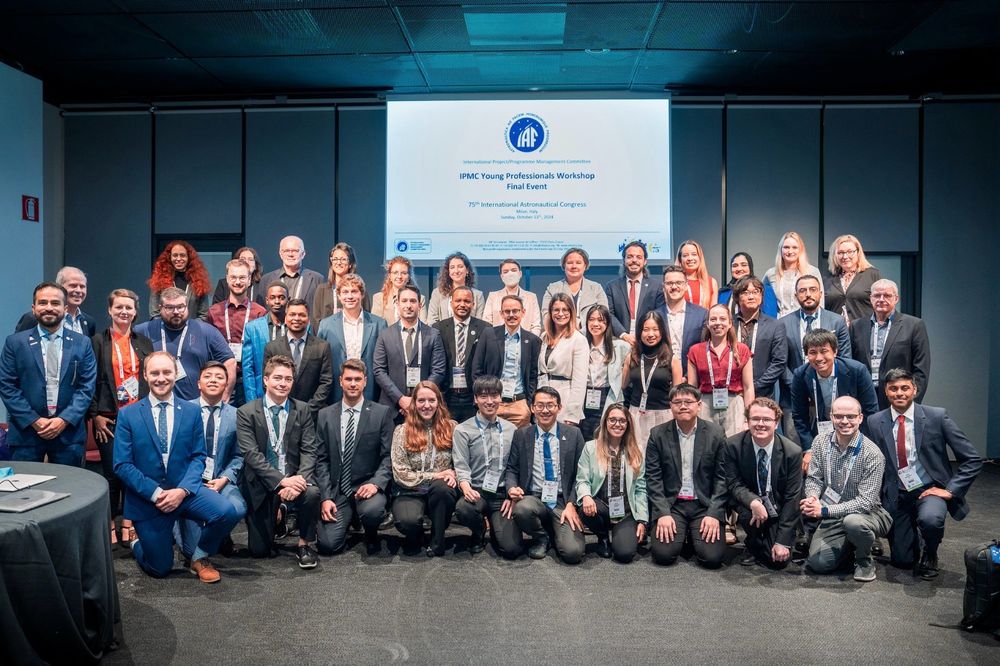 Group photo from the 2024 IAF IAC IPMC YP Workshop Final Event which was held in Milan, Italy, in October 2024. The group is of ~50 people in business smart clothes and most are wearing lanyards of the events. 