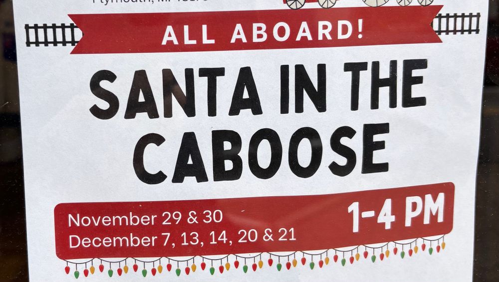 A sign for an event where kids can see Santa Claus in a train caboose in town, with the text reading “all aboard! Santa in the caboose. It kinda reads like it could be a sex thing